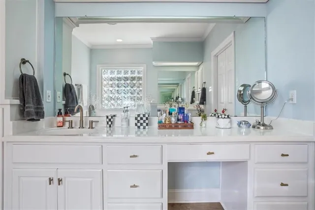 a bathroom with double vanity sink and a mirror