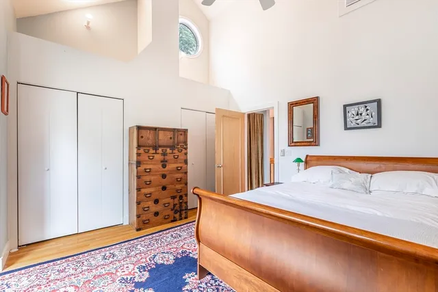 a bedroom with a bed and a painting on the wall