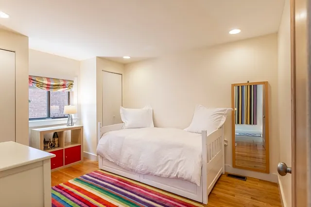 a bedroom with a bed and a book shelf