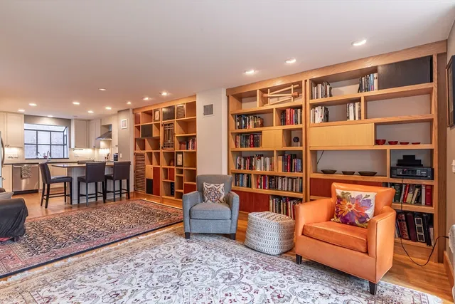a living room with furniture and a book shelf