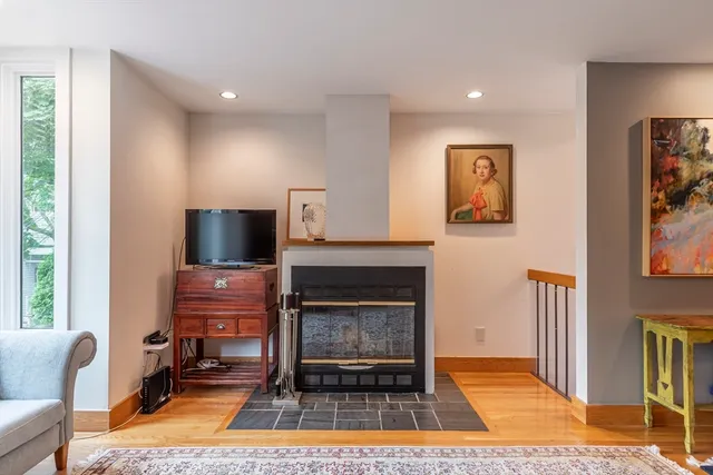 a living room with furniture a rug and a fireplace