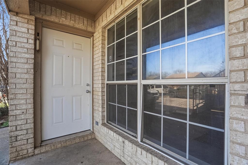 609 Race Street Crowley, TX 76036 - Photo 17 of 18 a view of an empty room with wooden floor and a window