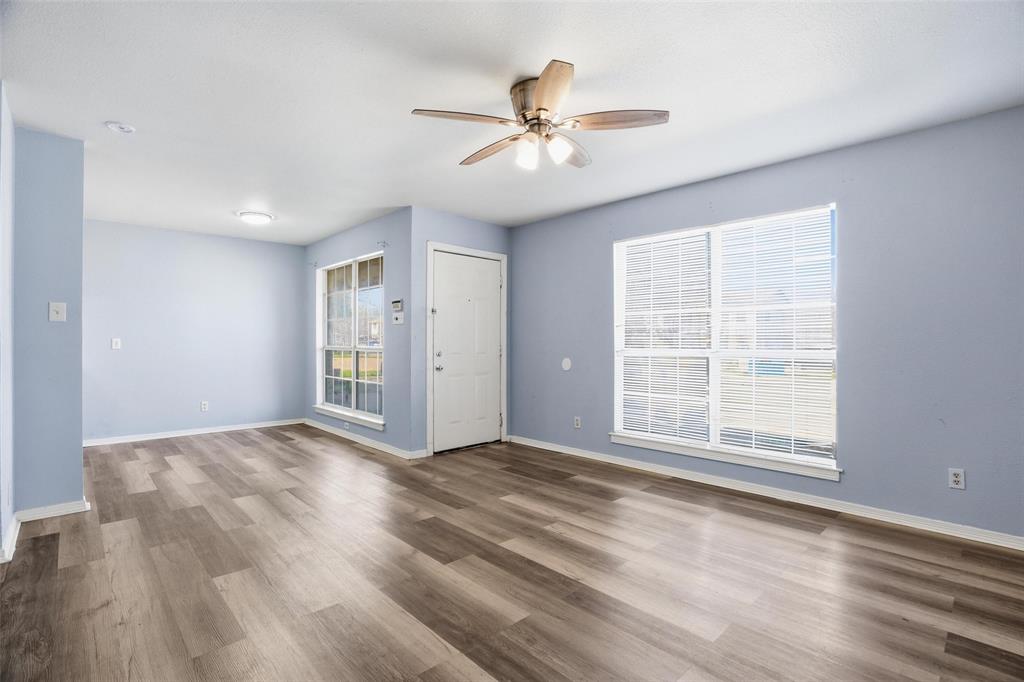 609 Race Street Crowley, TX 76036 - Photo 3 of 18 a view of an empty room with wooden floor and a window
