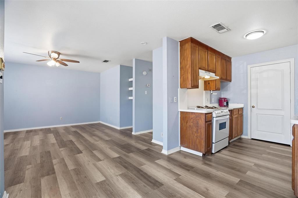 609 Race Street Crowley, TX 76036 - Photo 5 of 18 a view of a kitchen with a sink dishwasher and a microwave