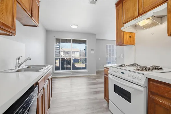 a kitchen with a stove and a sink