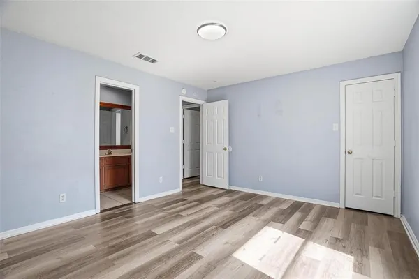 a view of a room with wooden floor and a sink