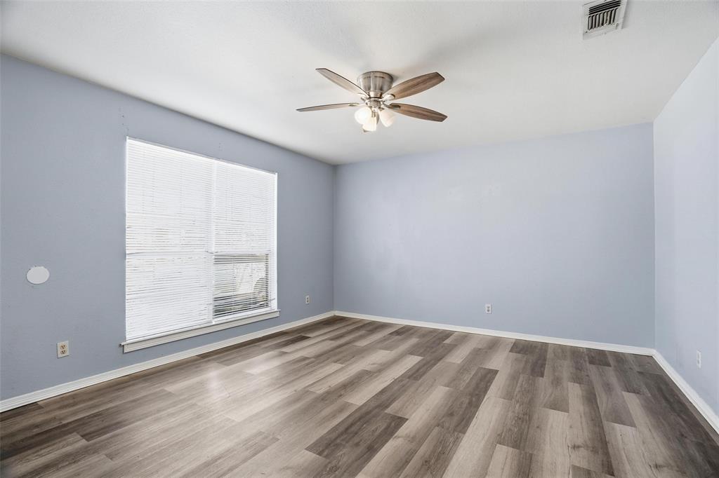 609 Race Street Crowley, TX 76036 - Photo 10 of 18 wooden floor in an empty room with a window