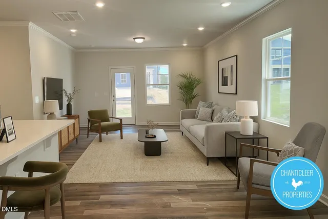 a living room with furniture a wooden floor and a large window
