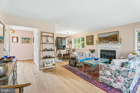 a living room with furniture large window and a fireplace