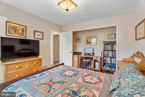 a bedroom with furniture and a flat screen tv