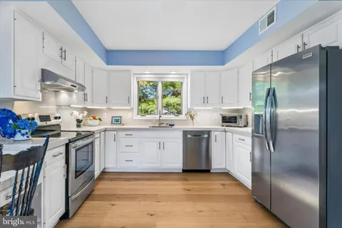 a kitchen with a refrigerator and a sink