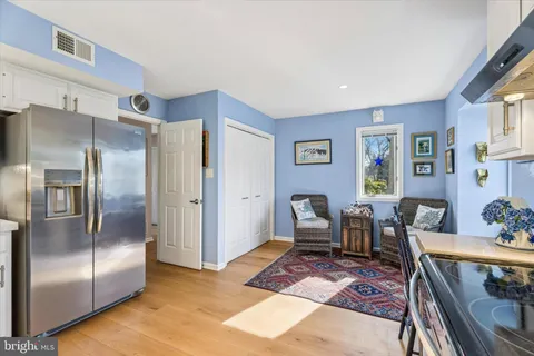 a kitchen with stainless steel appliances granite countertop a refrigerator and table