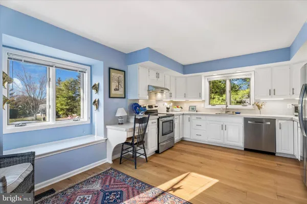 a kitchen with a stove a sink and a refrigerator
