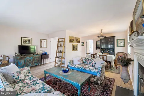 a living room with furniture a rug and a flat screen tv