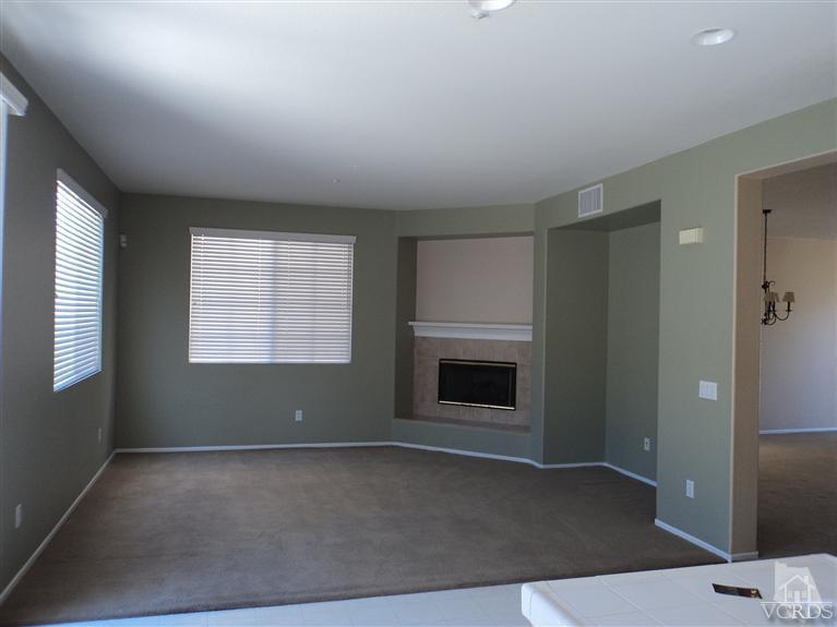 1113 Unidad Way Oxnard, CA 93030 - Photo 3 of 5 an empty room with windows and fireplace