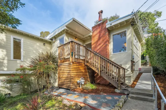 a living room with furniture a fireplace and a large window
