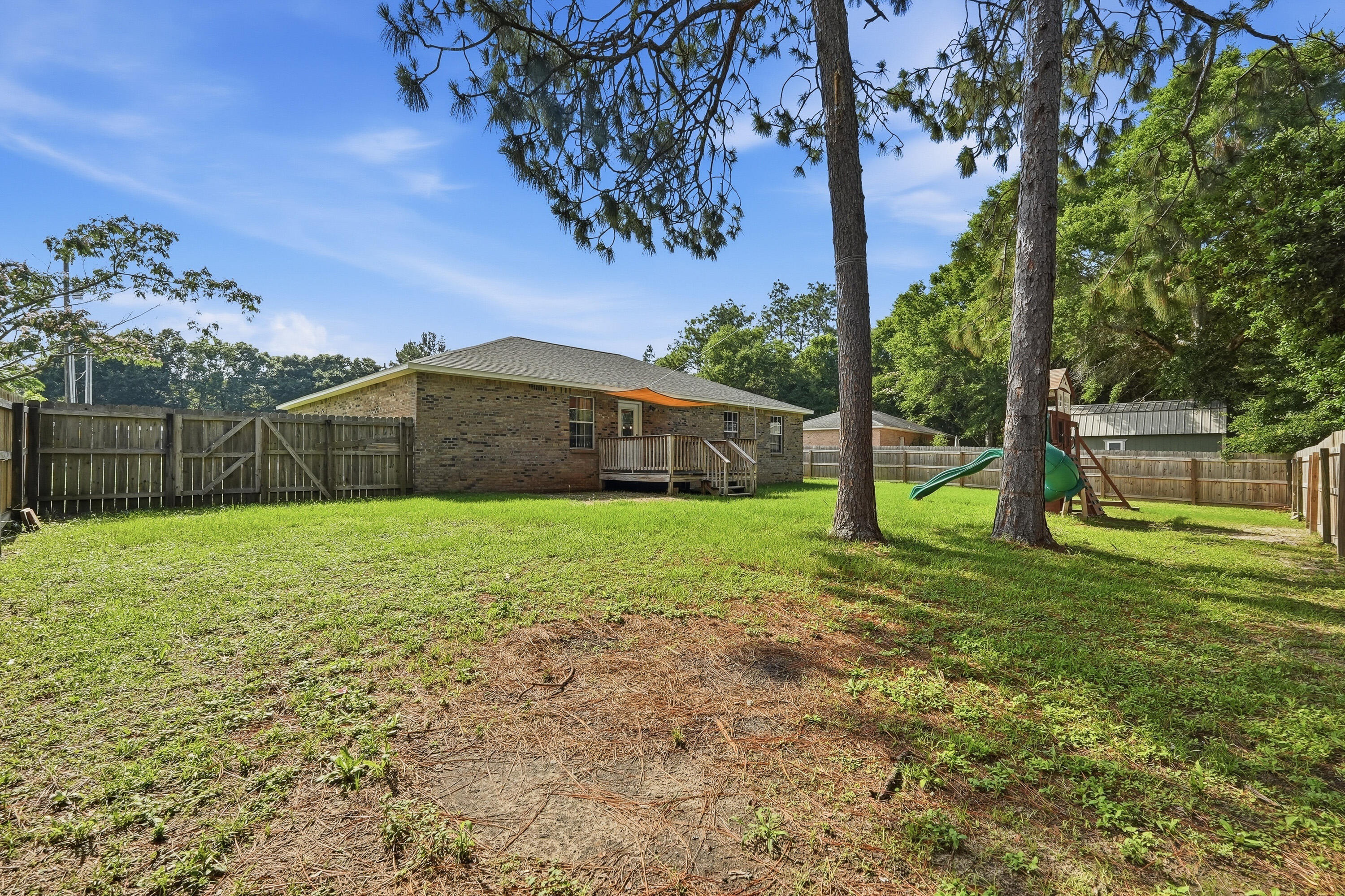 3033 Cabela Lane Crestview, FL 32539 - Photo 29 of 32 a view of a house with a backyard