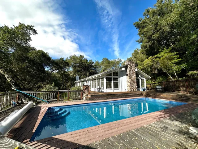 a view of house with a swimming pool