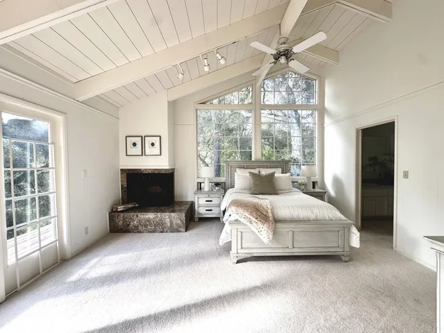 a spacious bedroom with a bed and a chandelier