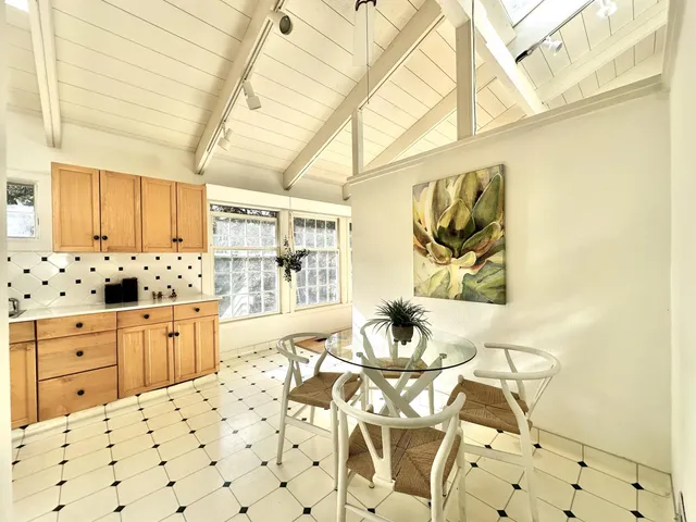 a large white kitchen with a large window