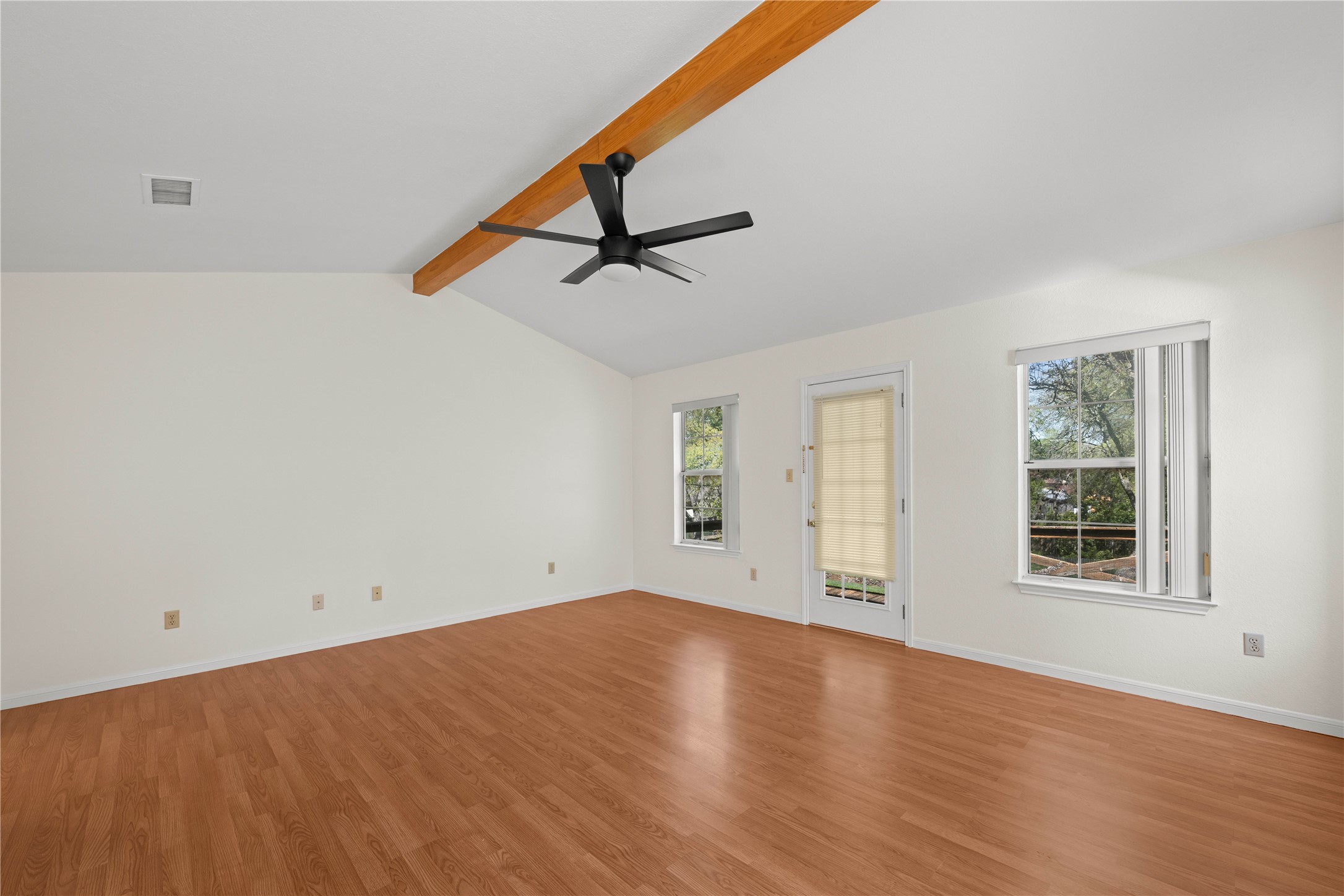 986 Benchmark Trail Belton, TX 76513 - Photo 14 of 31 an empty room with wooden floor cabinet and windows