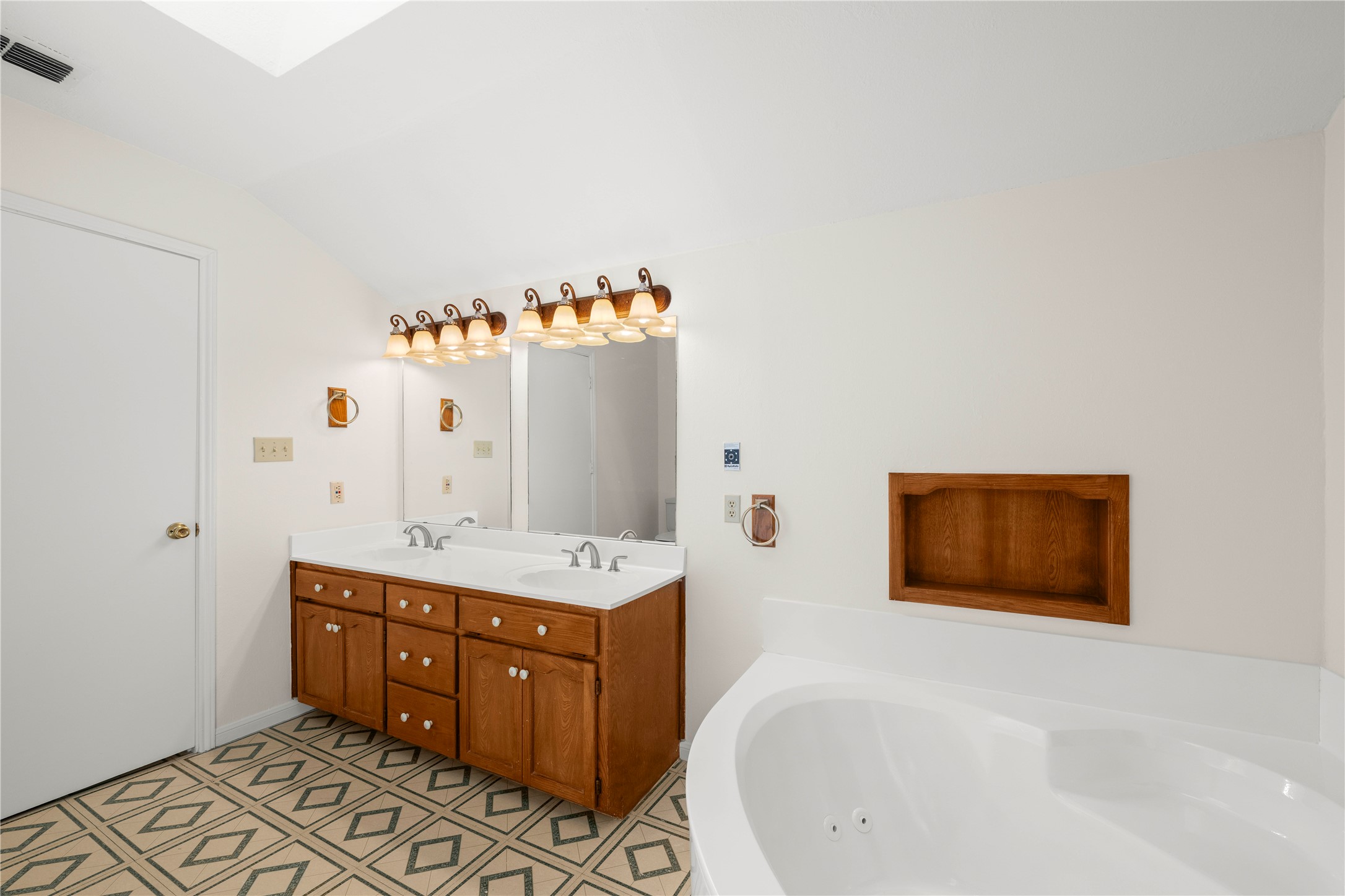 986 Benchmark Trail Belton, TX 76513 - Photo 16 of 31 a bathroom with a tub sink and mirror