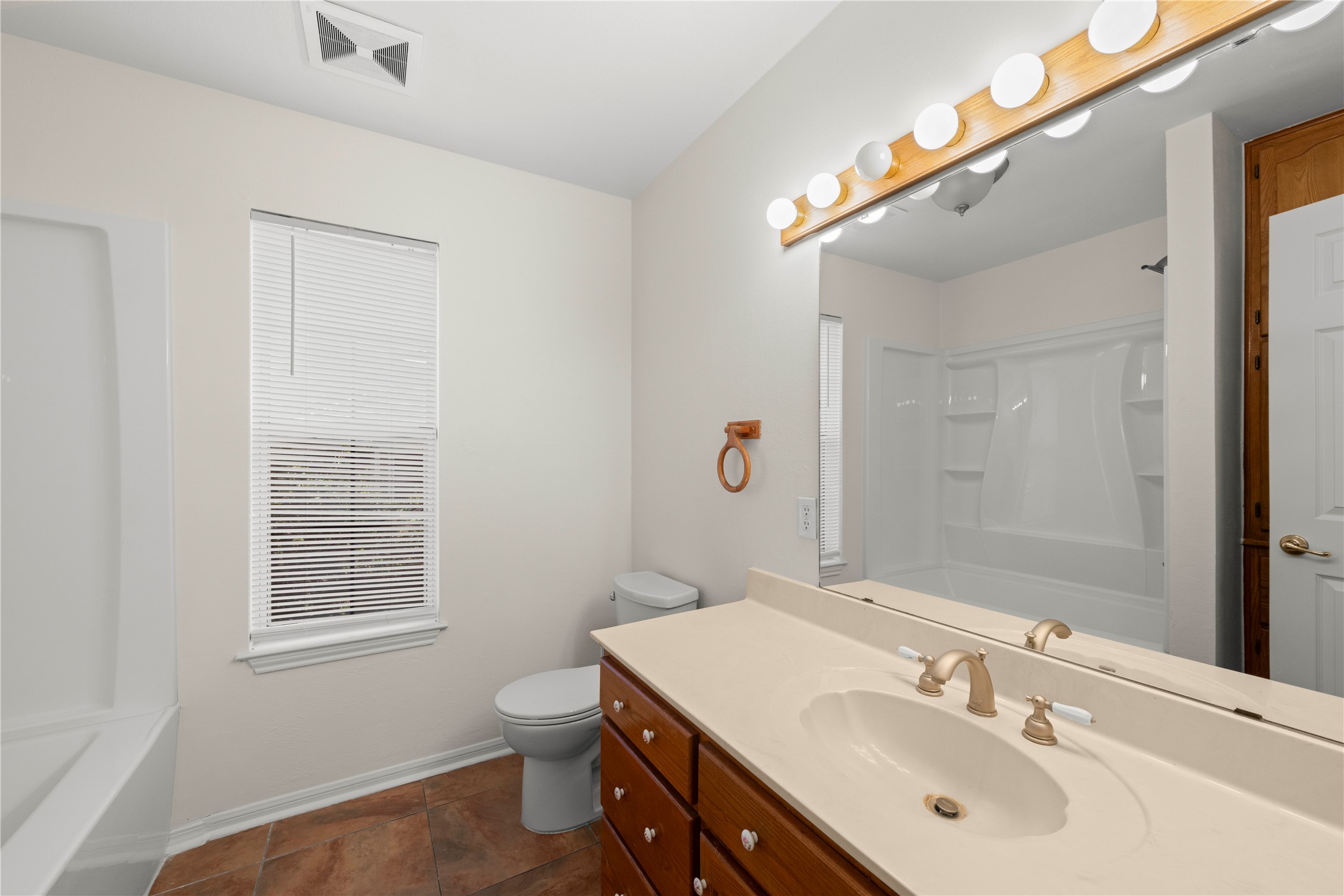 986 Benchmark Trail Belton, TX 76513 - Photo 23 of 31 a bathroom with a sink a toilet and shower