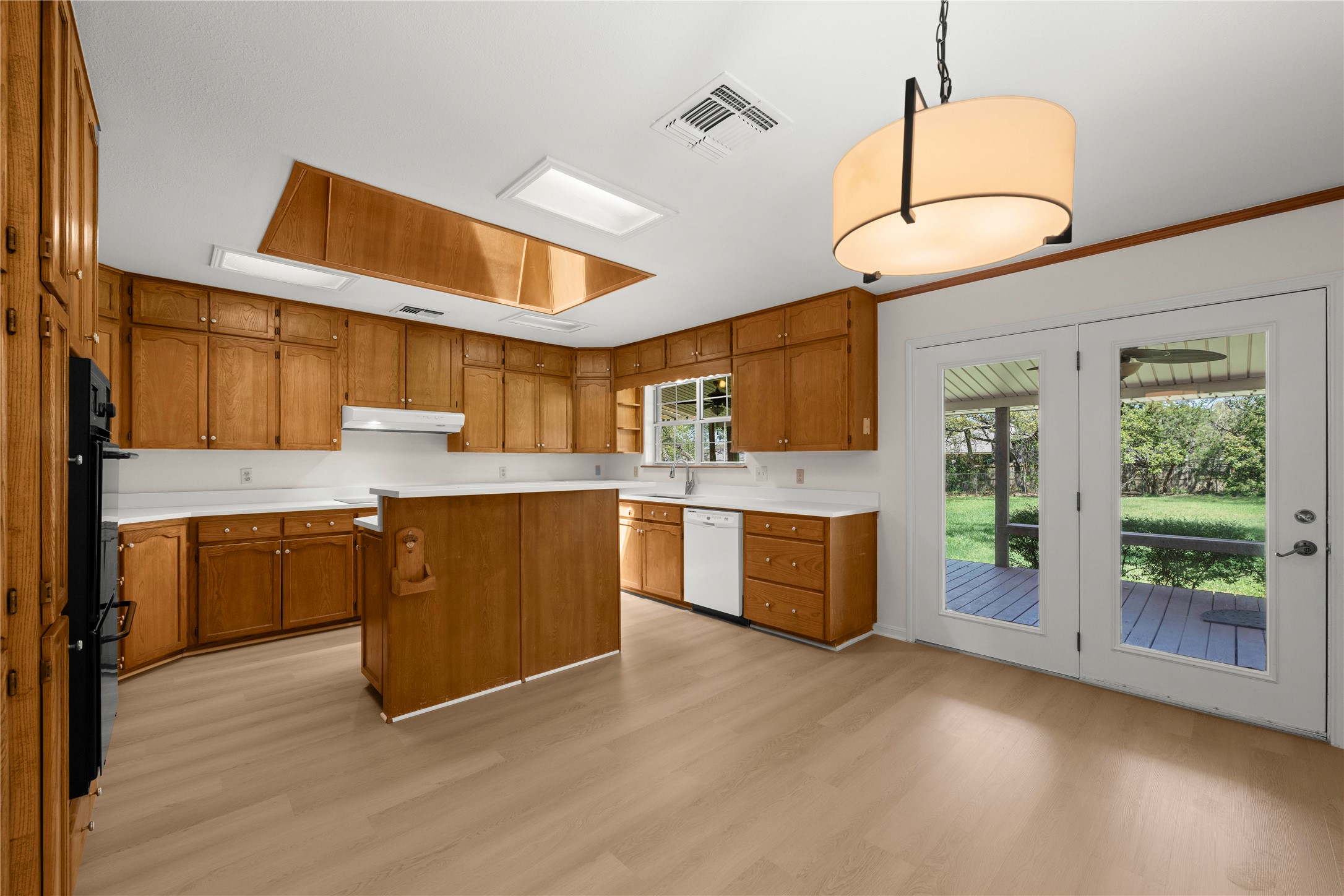 986 Benchmark Trail Belton, TX 76513 - Photo 7 of 31 a kitchen with stainless steel appliances granite countertop a sink a stove and a wooden floors