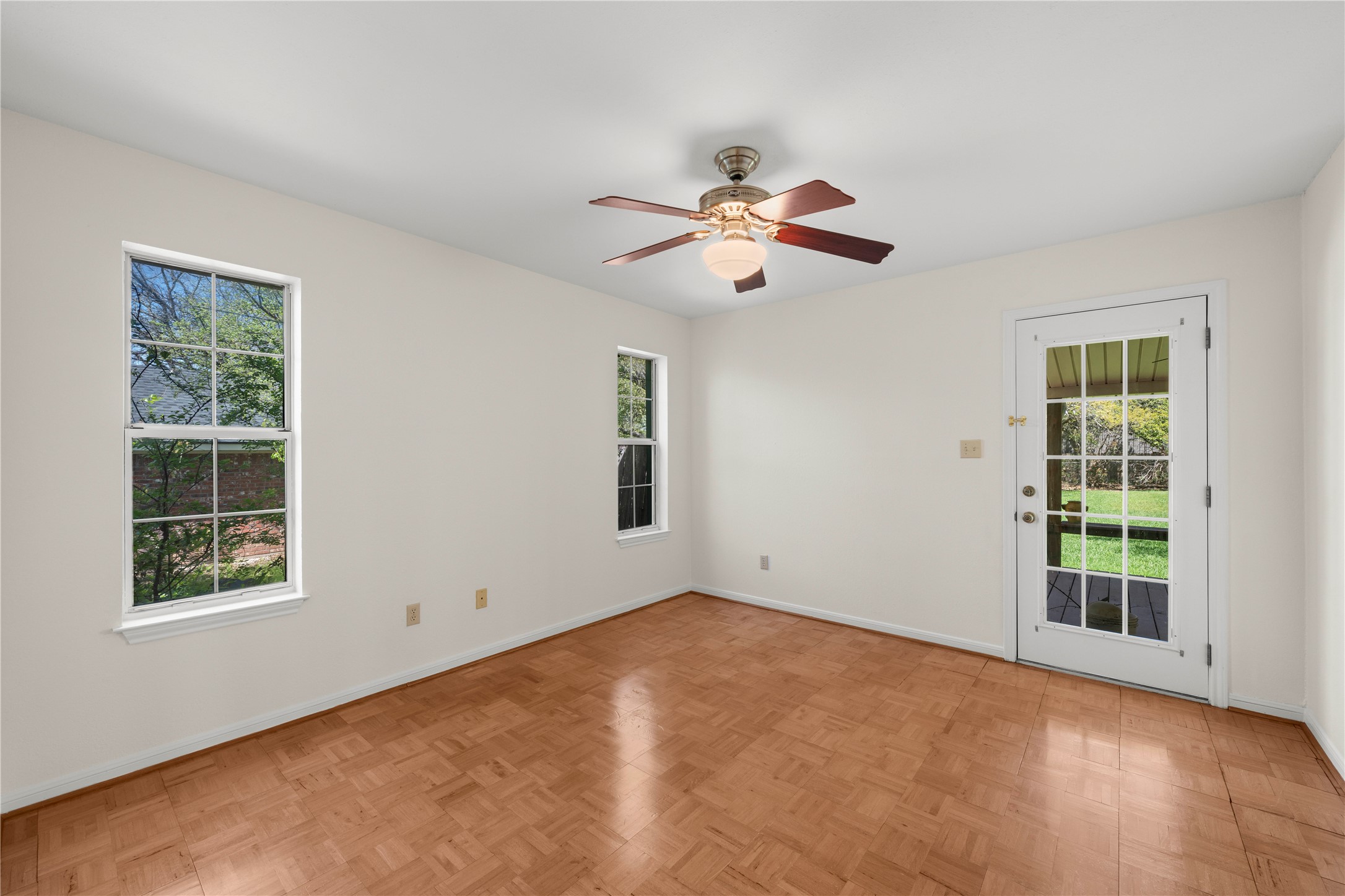 986 Benchmark Trail Belton, TX 76513 - Photo 9 of 31 an empty room with windows and chandelier fan