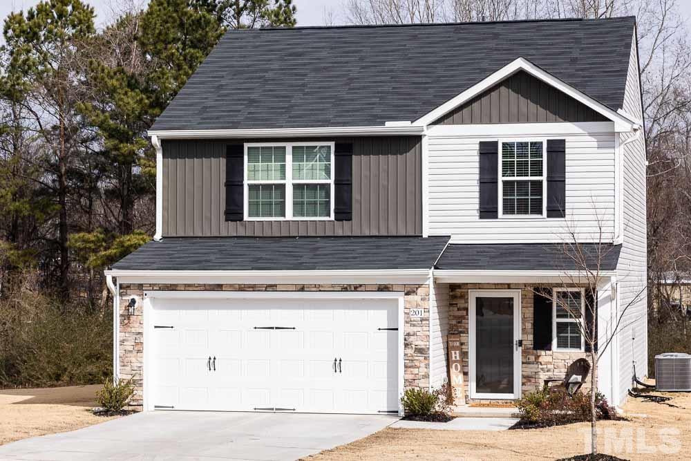 201 Rustling Way Zebulon, NC 27597 - Photo 1 of 30 a front view of a house with a yard