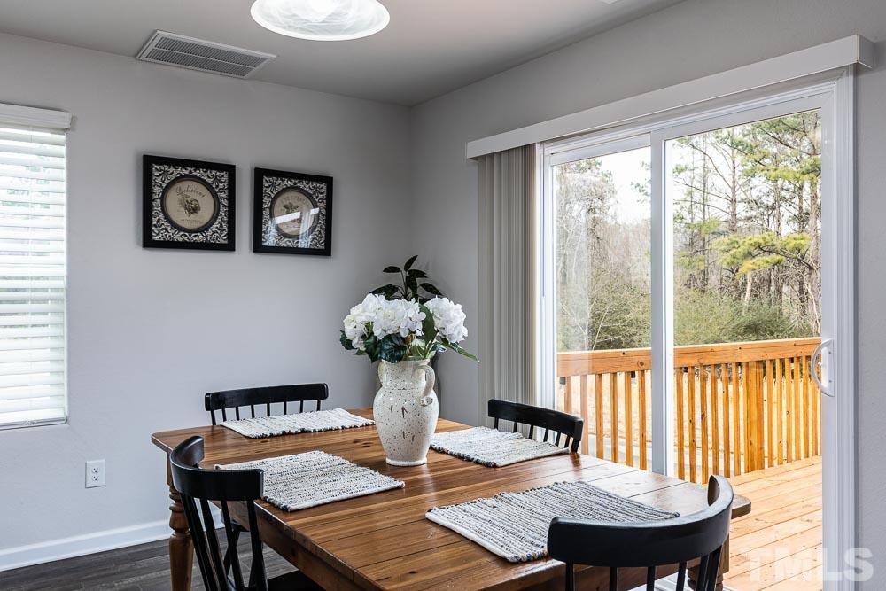 201 Rustling Way Zebulon, NC 27597 - Photo 10 of 30 a view of a dining room with furniture window and wooden floor