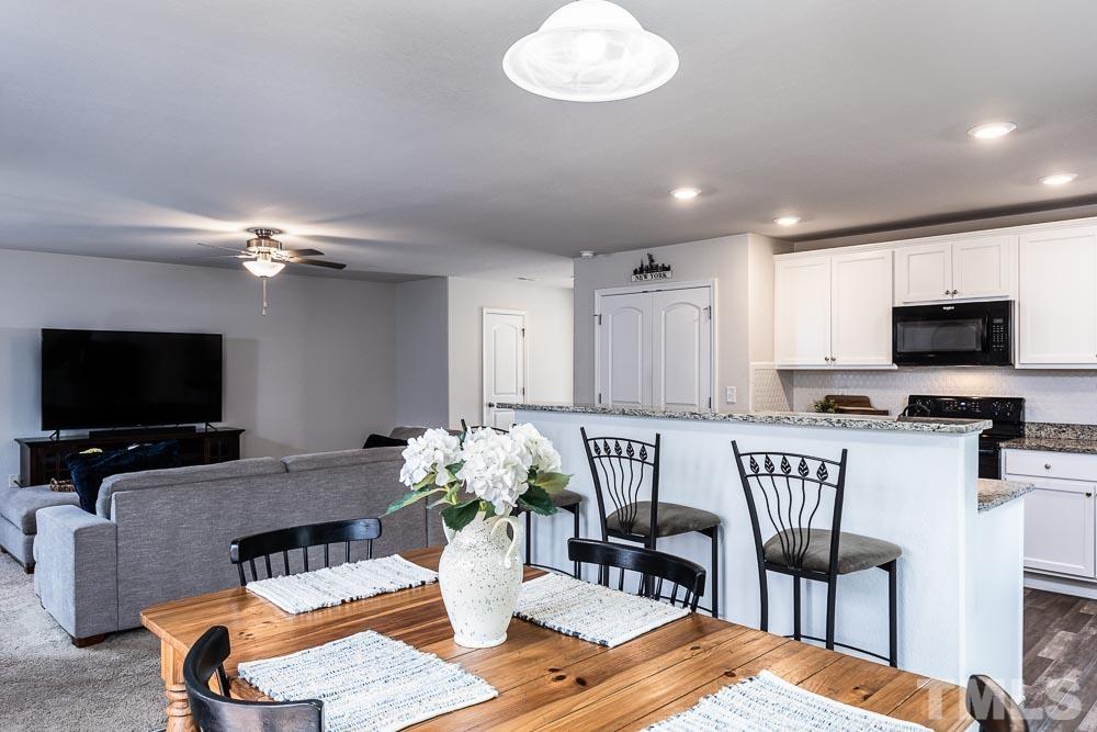 201 Rustling Way Zebulon, NC 27597 - Photo 11 of 30 a living room with furniture and a flat screen tv