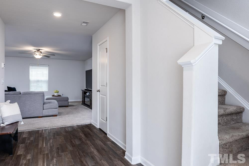 201 Rustling Way Zebulon, NC 27597 - Photo 12 of 30 a living room with furniture and a chandelier