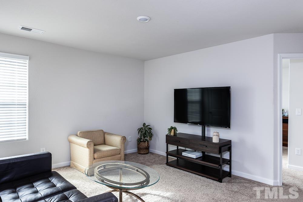 201 Rustling Way Zebulon, NC 27597 - Photo 13 of 30 a living room with furniture and a flat screen tv