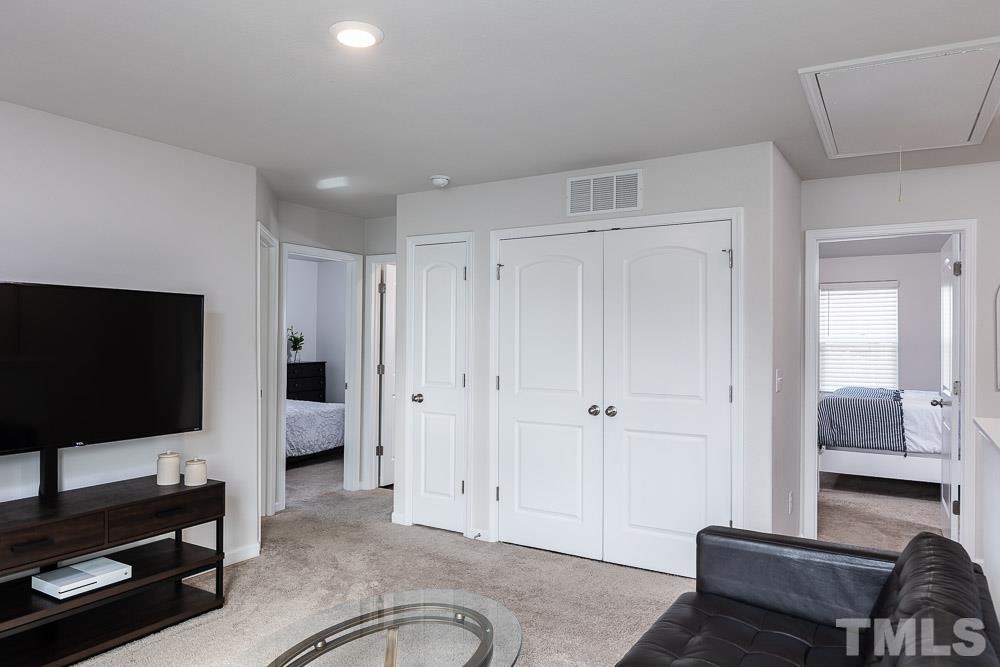 201 Rustling Way Zebulon, NC 27597 - Photo 14 of 30 a living room with furniture and a flat screen tv