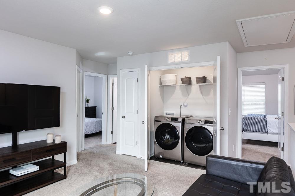 201 Rustling Way Zebulon, NC 27597 - Photo 15 of 30 a view of a livingroom with furniture and a flat screen tv