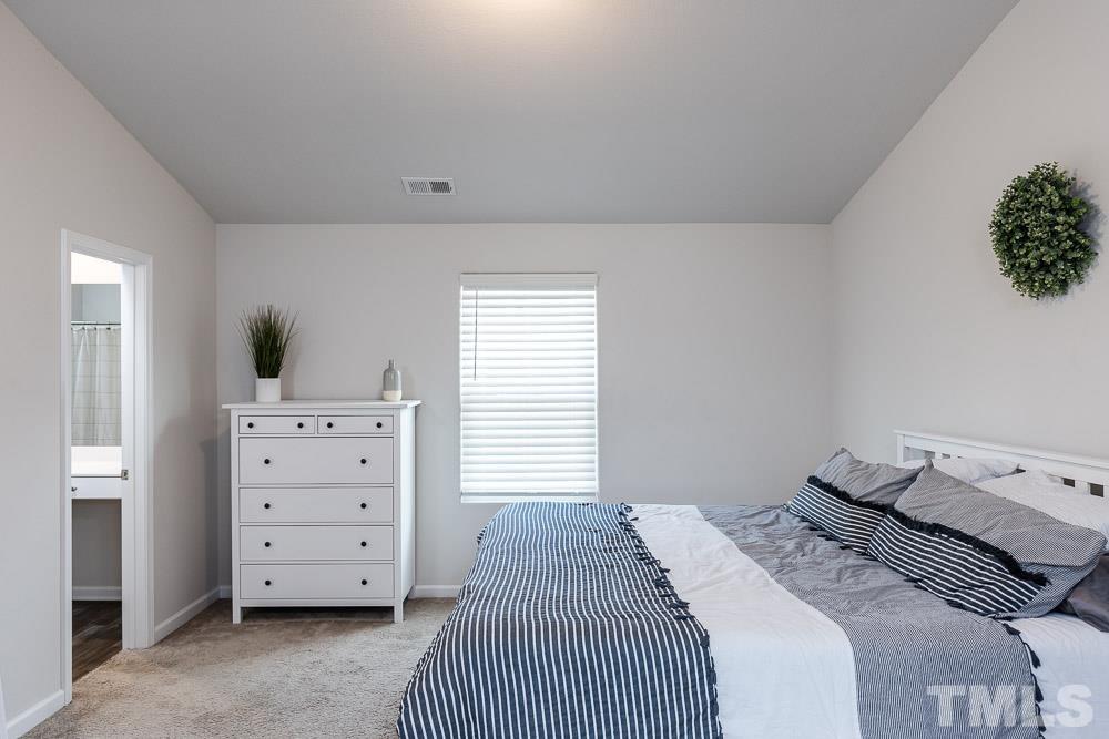 201 Rustling Way Zebulon, NC 27597 - Photo 16 of 30 a bedroom with a bed and a dresser