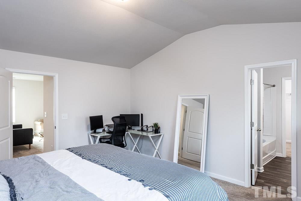 201 Rustling Way Zebulon, NC 27597 - Photo 17 of 30 a bedroom with a bed and furniture