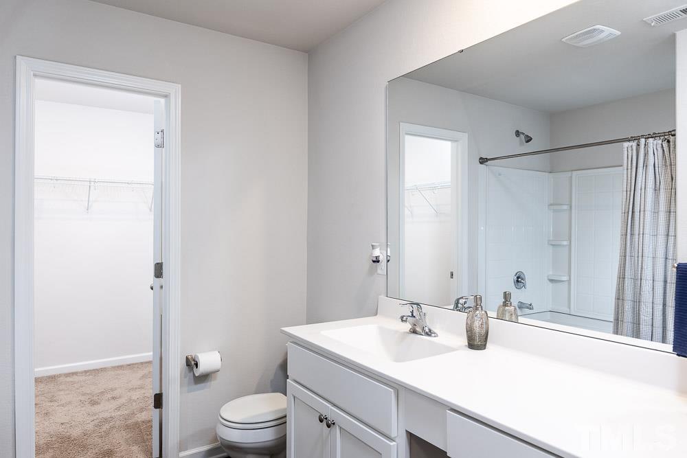 201 Rustling Way Zebulon, NC 27597 - Photo 18 of 30 a bathroom with a sink a toilet and shower