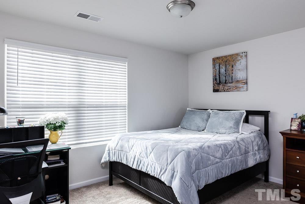 201 Rustling Way Zebulon, NC 27597 - Photo 20 of 30 a bedroom with a bed and a desk
