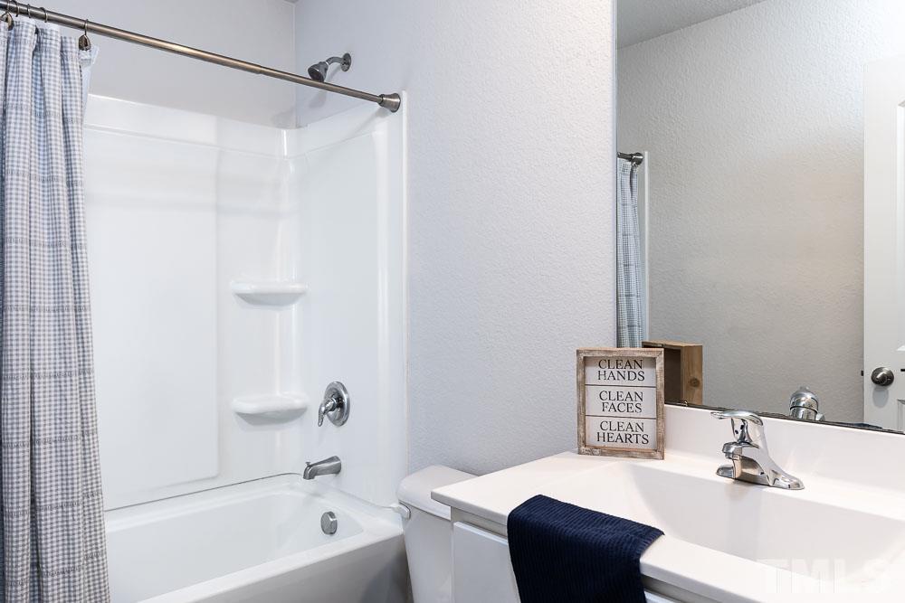 201 Rustling Way Zebulon, NC 27597 - Photo 22 of 30 a bathroom with a sink toilet and shower