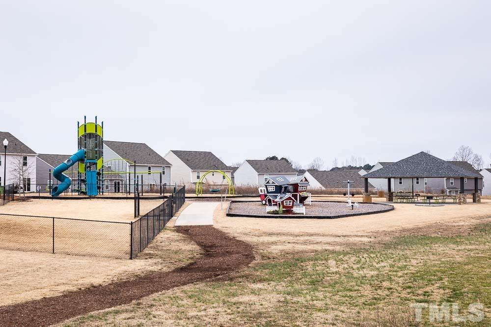 201 Rustling Way Zebulon, NC 27597 - Photo 29 of 30 a view of a house with a yard and sitting area
