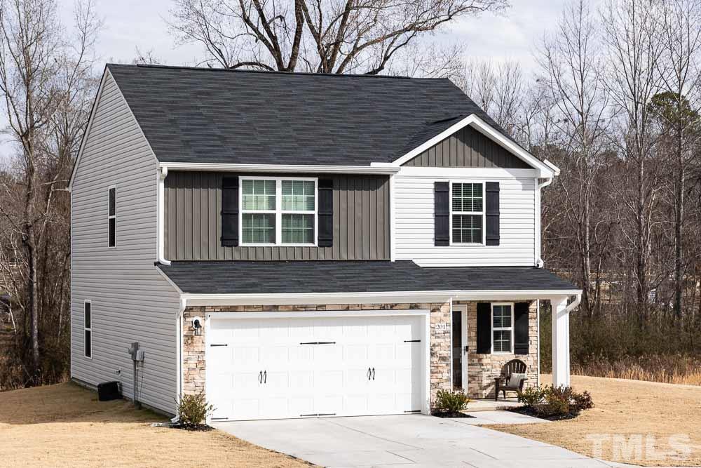 201 Rustling Way Zebulon, NC 27597 - Photo 4 of 30 a front view of a house with garden