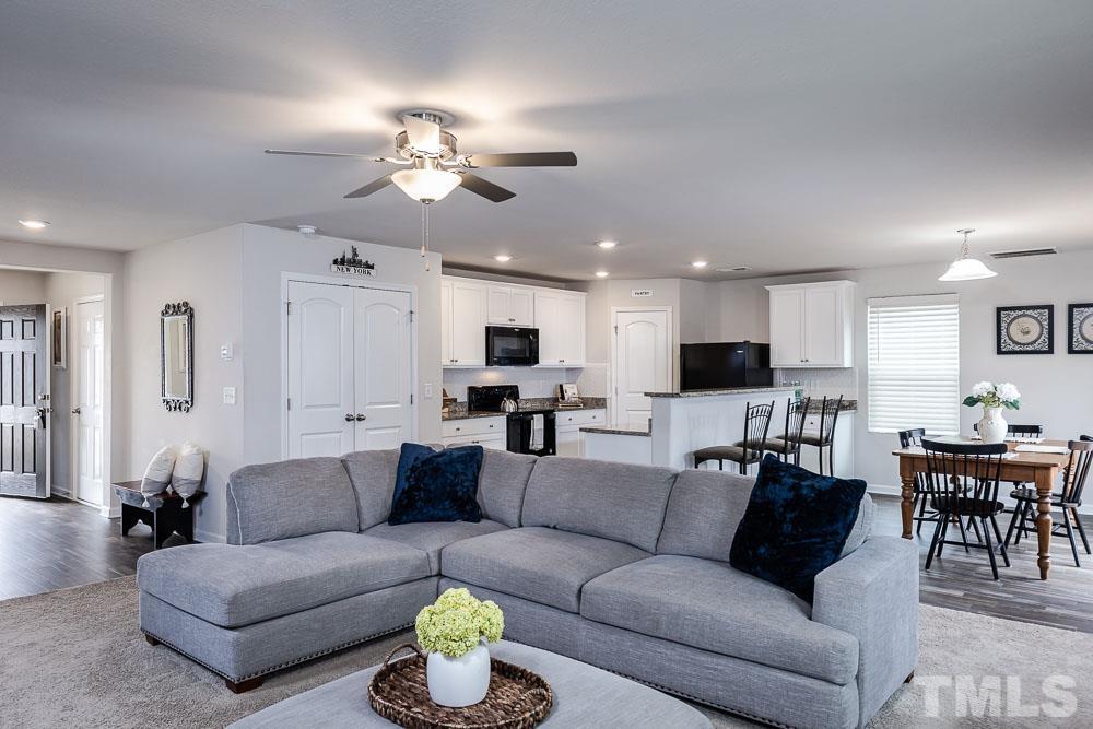 201 Rustling Way Zebulon, NC 27597 - Photo 30 of 30 a living room with furniture kitchen view and a chandelier