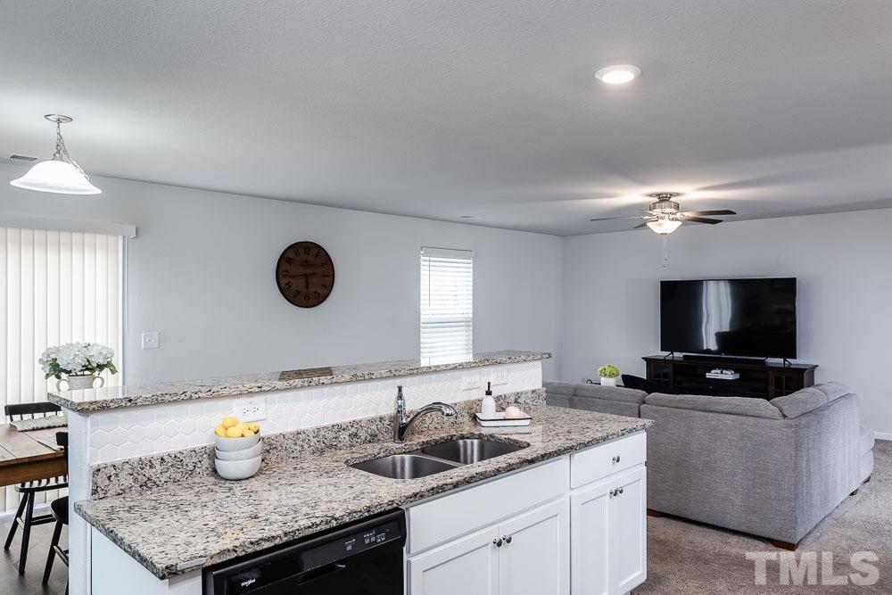 201 Rustling Way Zebulon, NC 27597 - Photo 8 of 30 a kitchen with a sink a microwave and cabinets