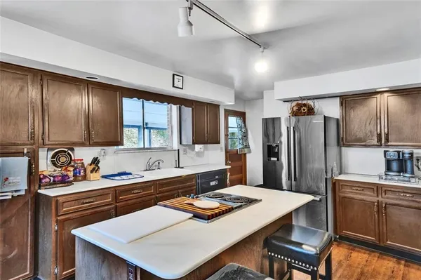 a kitchen with stainless steel appliances a sink stove and refrigerator