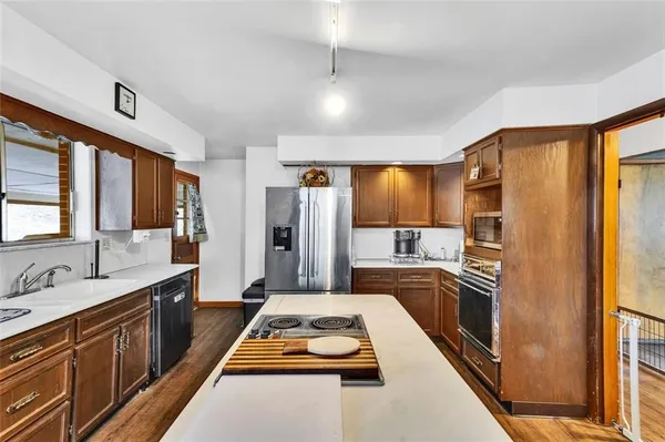 a kitchen with refrigerator a sink and cabinets