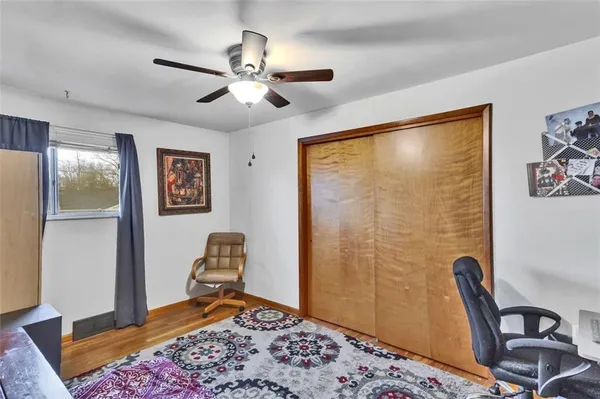 a bedroom with a bed and a dresser