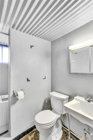 a white toilet sitting next to a bathroom sink