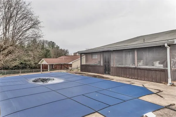 a view of a patio with a table and chairs and wooden fence